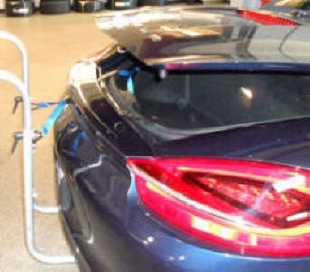 Porsche Boxter trunklids for 981 & 718 open without restrictions. Straps from inside the trunk go under the spoiler. Paint is Protected